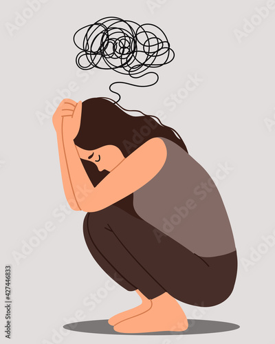 Young depressed female sitting on the floor and holding their knees.Negative emotions - irritation, anger and also for depression, anxiety, mental disorders.