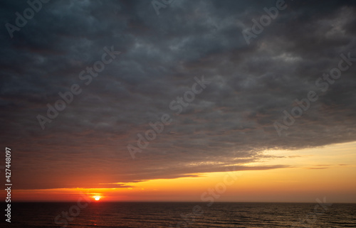 sunset sunrise over the ocean (ID: 427448097)