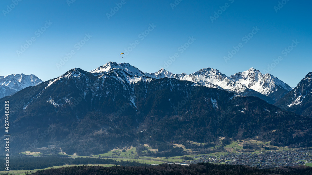 Paragleiter über dem Walgau, Para glider over the valley of Ill, with the mountains from Brand in the background. Zimba und Mondspitze, verschneite Berge im Hintergrund Paragleiter über dem Walgau, Para glider over the valley of Ill, with the mountains from Brand in the background. Zimba und Mondspitze, verschneite Berge im Hintergrund