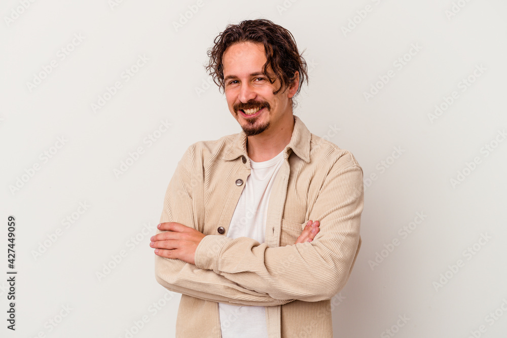 Young caucasian man isolated on white background who feels confident, crossing arms with determination. Young caucasian man isolated on white background who feels confident, crossing arms with determination.