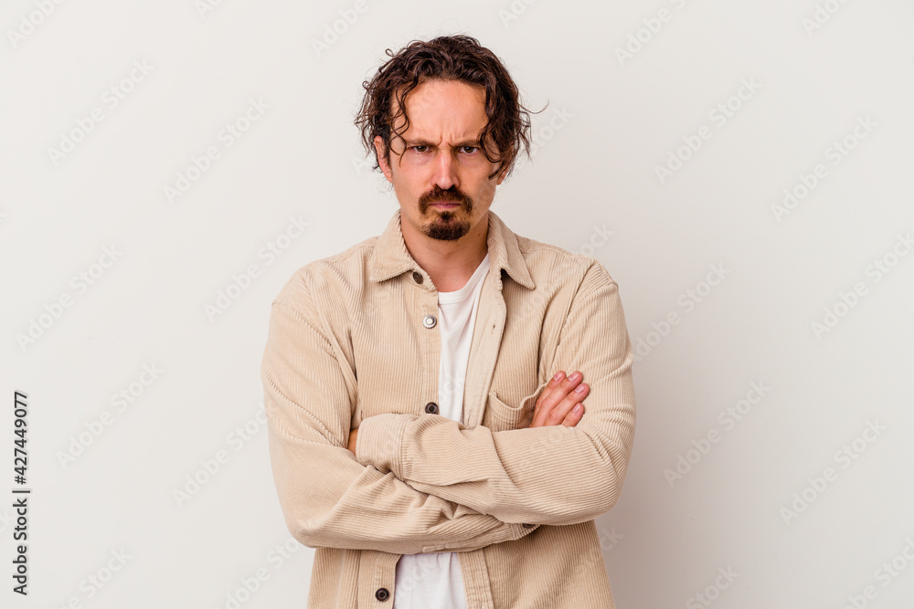 Fototapeta premium Young caucasian man isolated on white background blows cheeks, has tired expression. Facial expression concept.