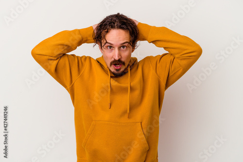 Young caucasian man isolated on white background screaming, very excited, passionate, satisfied with something.