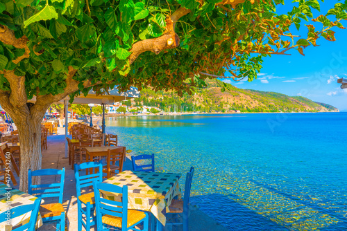 Greece Evoia lake, colorful chairs of a coffee shop by the sea at summer photo