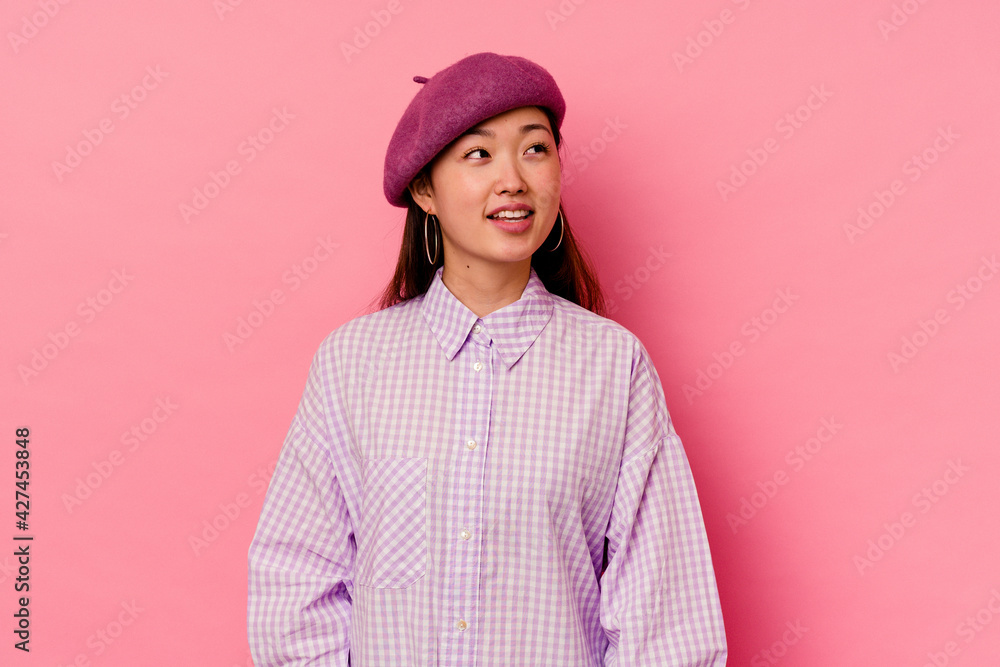 Young chinese woman isolated on pink background relaxed and happy laughing, neck stretched showing teeth. Young chinese woman isolated on pink background relaxed and happy laughing, neck stretched showing teeth.