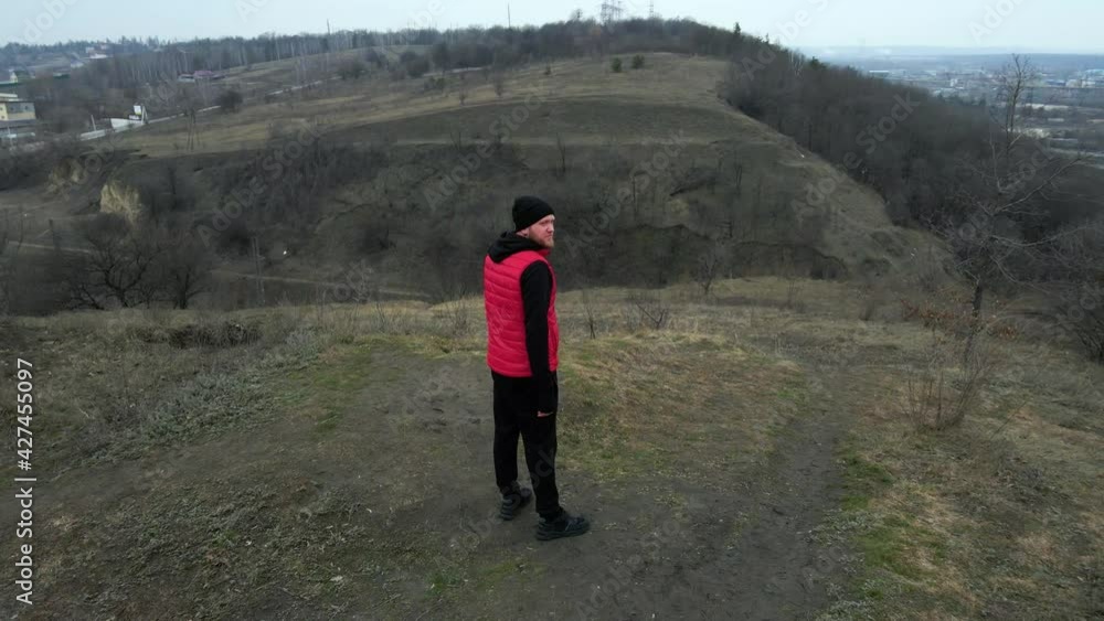 Aerial view drone Athletic man in red west running in the nature Aerial view drone Athletic man in red west running in the nature