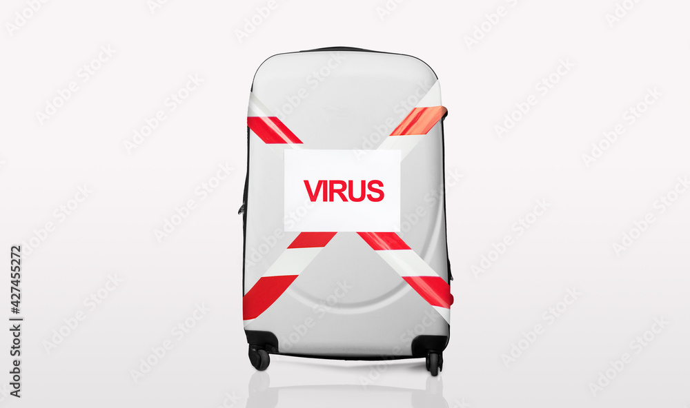 Fototapeta premium Grey suitcase wrapped in red and white barrier tape