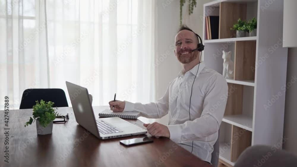 A Nice mature man working on laptop at home A Nice mature man working on laptop at home