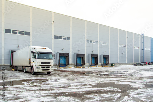 Truck while loading in a big distribution warehouse with gates for for loading goods and trucks © Roman