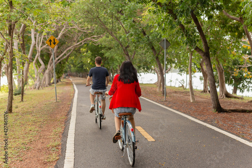 Wallpaper Mural Back view of couple riding bicycles in the park. Torontodigital.ca