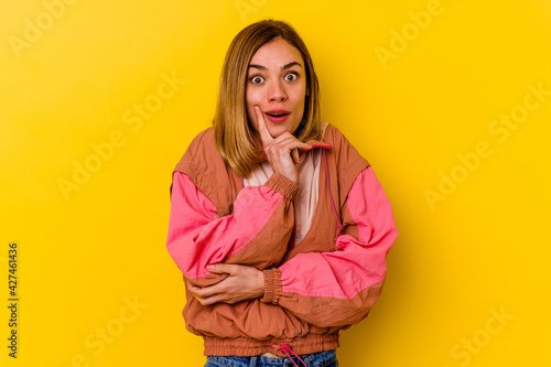 Young caucasian skinny woman isolated on yellow background having some great idea, concept of creativity.