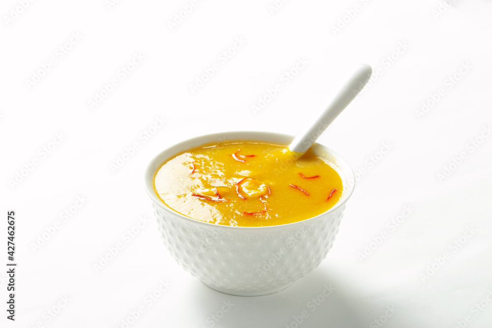 Aamras is plain Haapus or Alphonso Mango Puree/Pulp with kesar/ saffron topping. Aam Ras is a delicious Indian seasonal Dessert recipe. Served in a white bowl on white background Aamras is plain Haapus or Alphonso Mango Puree/Pulp with kesar/ saffron topping. Aam Ras is a delicious Indian seasonal Dessert recipe. Served in a white bowl on white background