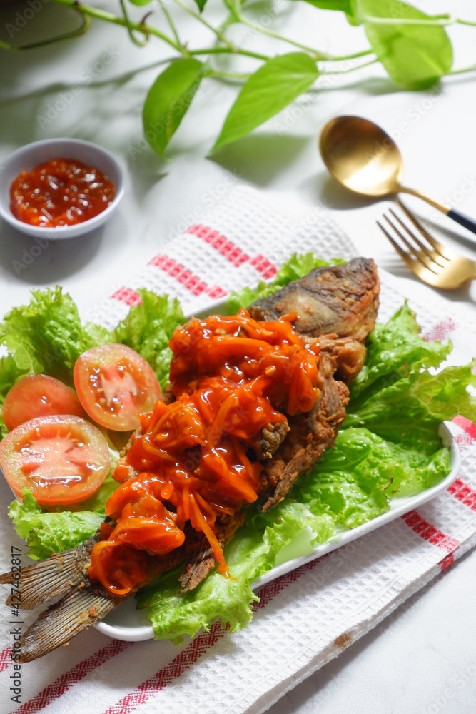 fried crispy fish with sweet and sour sauce in a plate fried crispy fish with sweet and sour sauce in a plate
