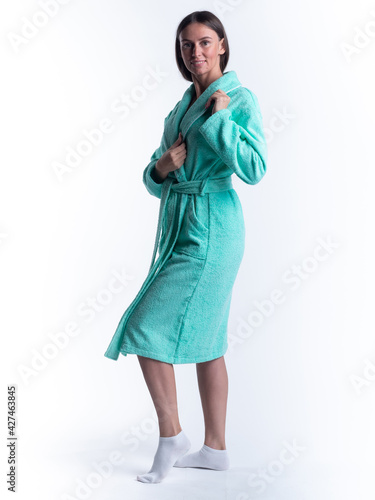 woman in a Bathrobe on an isolated white background with a smile on her face. © Evgeny Leontiev