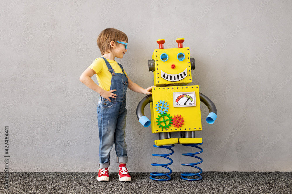 Happy child with toy robot Stock Photo | Adobe Stock