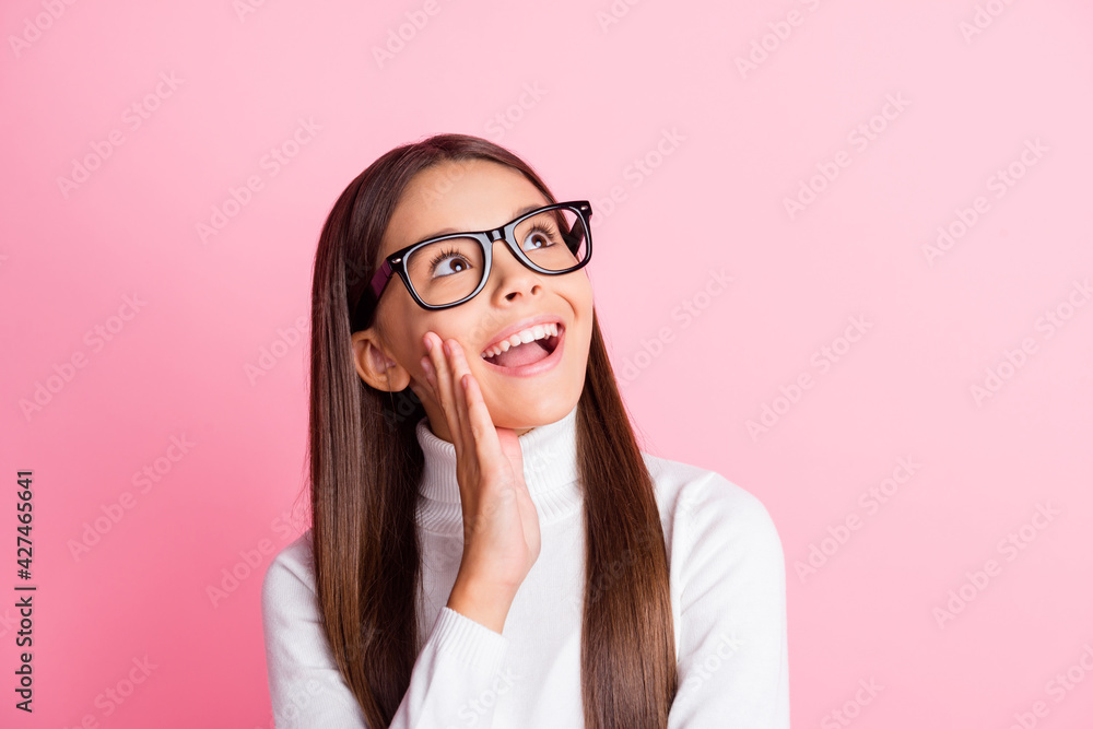 Photo of charming cute young girl wear white jumper spectacles arm cheek looking empty space isolated pink color background Photo of charming cute young girl wear white jumper spectacles arm cheek looking empty space isolated pink color background