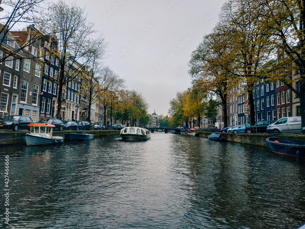 Amsterdam, Netherlands - November 01, 2019: view on the city architecture from channel boat at the autumn weather