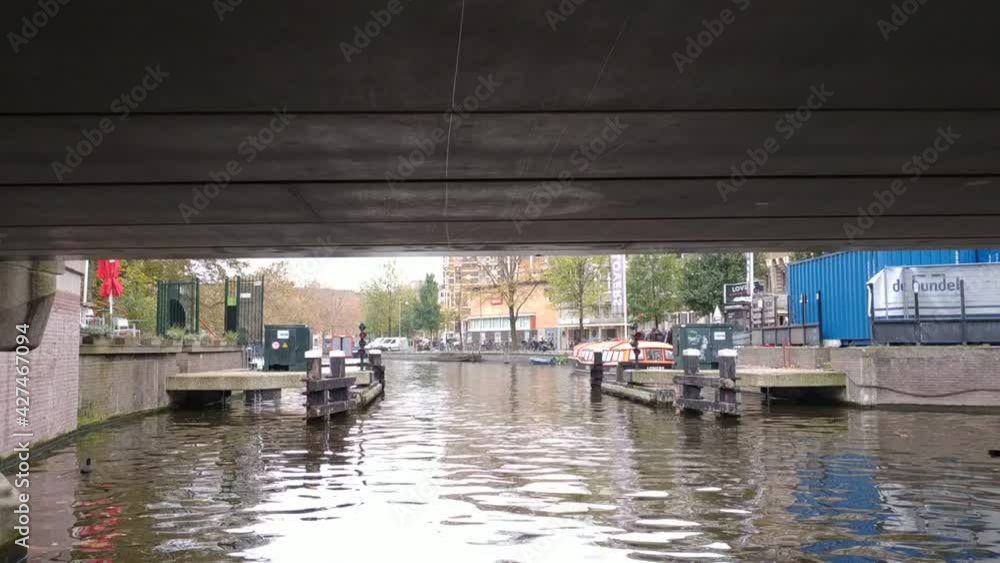 Amsterdam, Netherlands - November 01, 2019: view on the city architecture from channel boat at the autumn weather Amsterdam, Netherlands - November 01, 2019: view on the city architecture from channel boat at the autumn weather