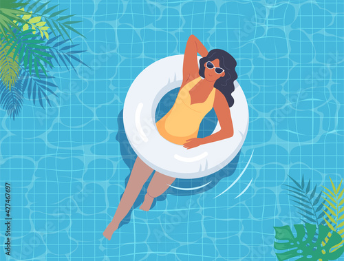 Young woman swimming in the pool with white lifebuoy