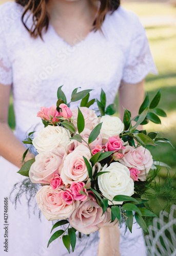 Bride holds beautiful vibrant wedding bouquet