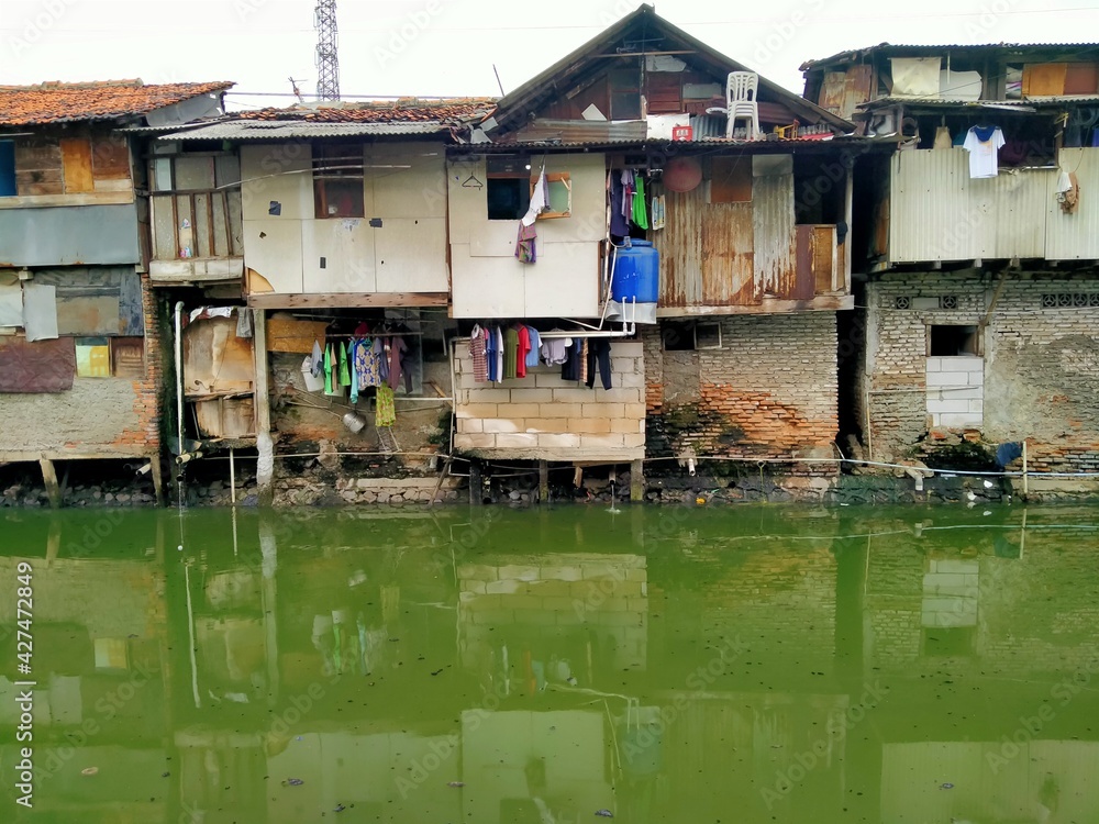 Sungai Duri, Roxy mas, Jakarta, Indonesia - (04-03-2021) :The atmosphere of a densely populated settlement standing on the river bank Sungai Duri, Roxy mas, Jakarta, Indonesia - (04-03-2021) :The atmosphere of a densely populated settlement standing on the river bank
