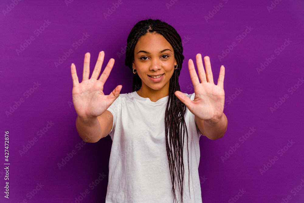 Young african american woman isolated on yellow background showing number ten with hands. Young african american woman isolated on yellow background showing number ten with hands.