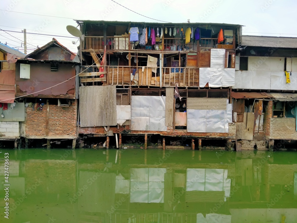 The atmosphere of a densely populated settlement standing on the river bank The atmosphere of a densely populated settlement standing on the river bank