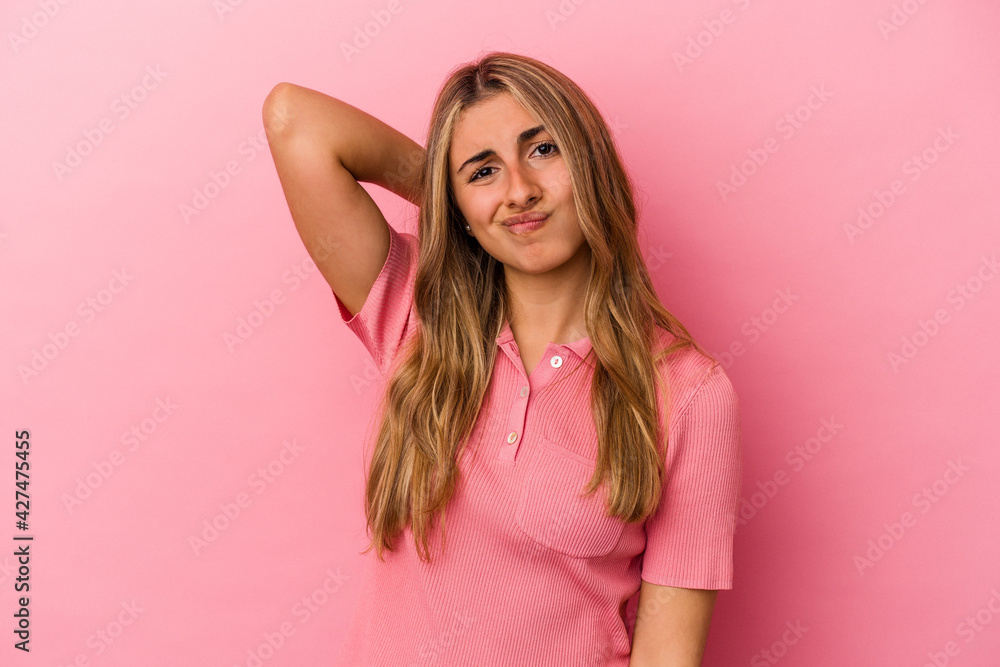 Young blonde caucasian woman isolated on pink background suffering neck pain due to sedentary lifestyle. Young blonde caucasian woman isolated on pink background suffering neck pain due to sedentary lifestyle.