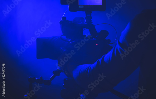 Videographer with Digital Camera Taking Shot © Tomasz Zajda