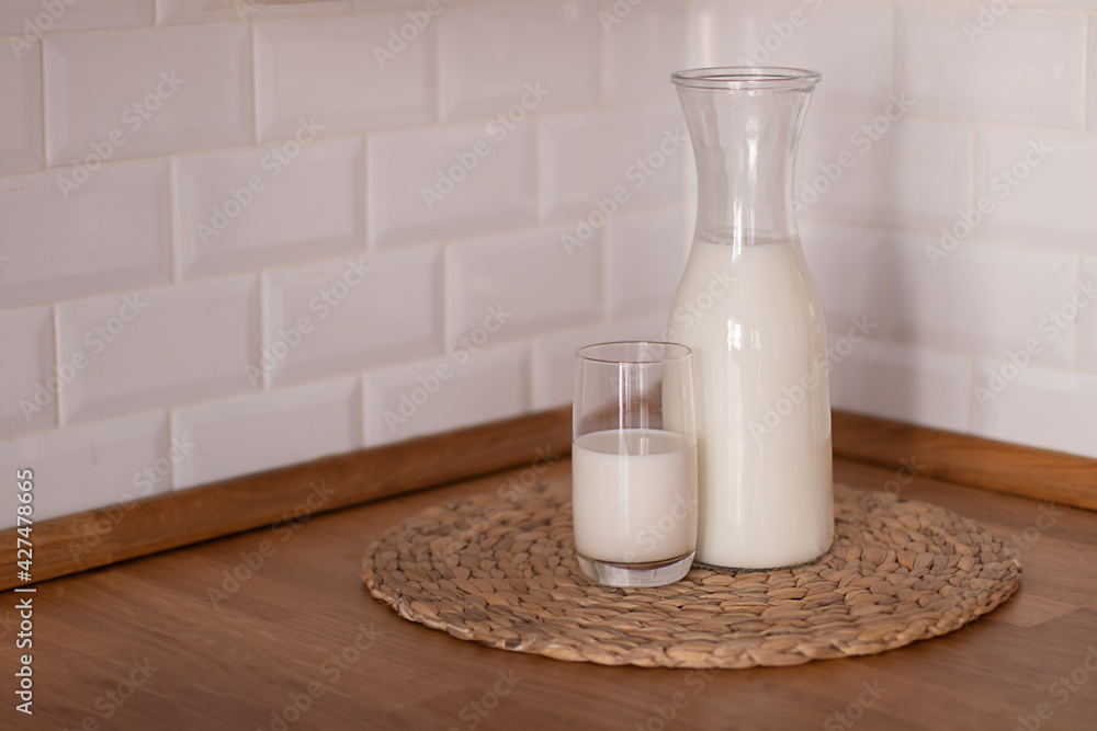 Happy Day of Milk. Milk jug and glass on light background Happy Day of Milk. Milk jug and glass on light background