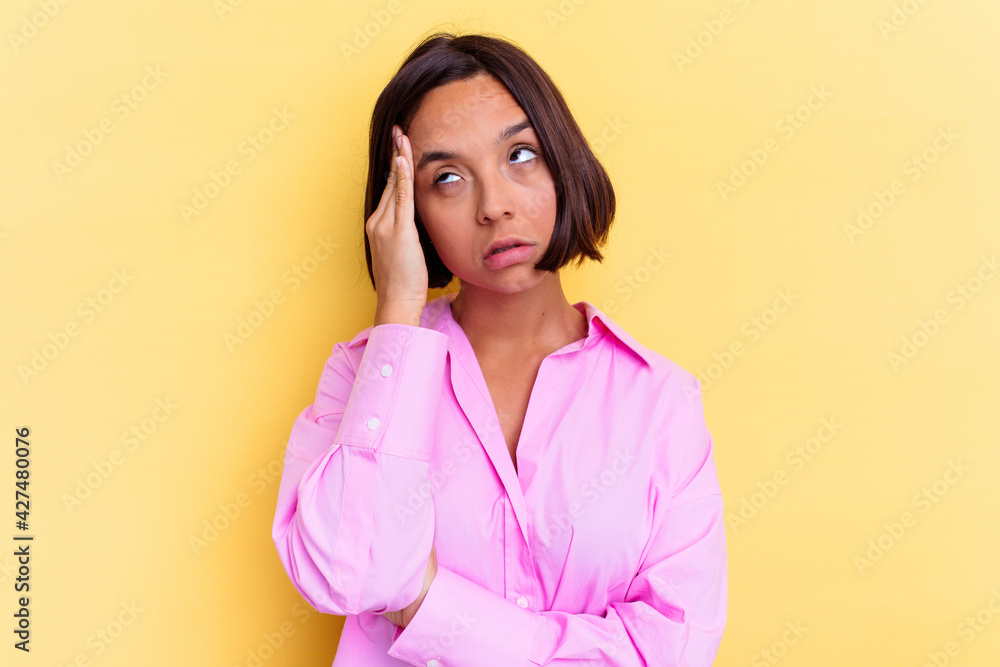 Young mixed race woman isolated on yellow background tired and very sleepy keeping hand on head. Young mixed race woman isolated on yellow background tired and very sleepy keeping hand on head.