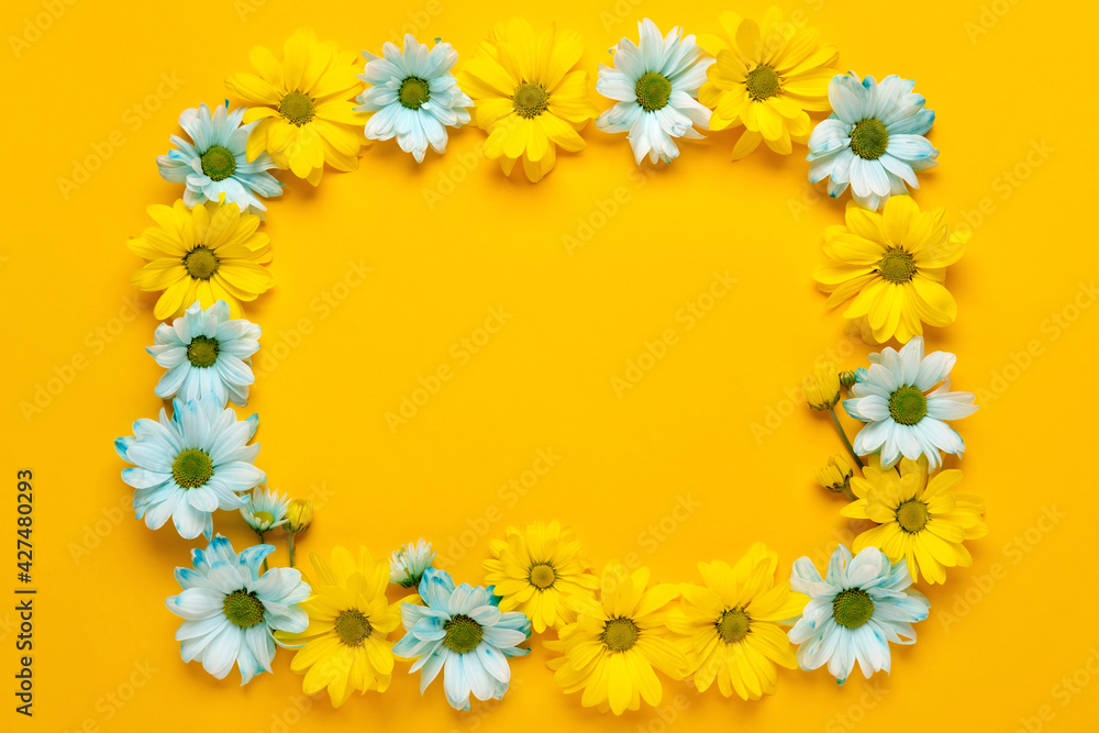 Spring flowers frame. Floral wreath on yellow background. Springtime. Flat lay, top view.