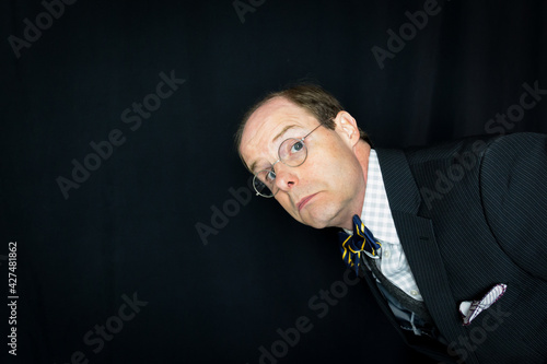 Portrait of Stuffy Man in Suit and Bow Tie Frowning Disapprovingly.  Vintage Style and Retro Fashion. photo