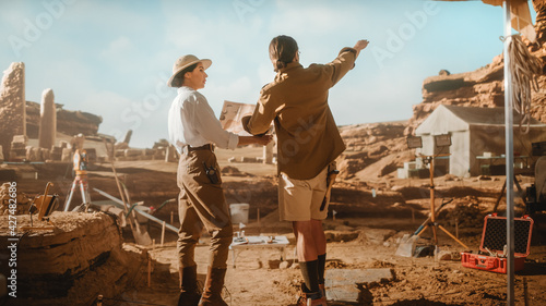 Archaeological Digging Site: Two Great Archeologists Work on Excavation Site, Look around, Use Map to Inspect Newly Discovered Ancient Civilization Architectural Site, Planning Work.