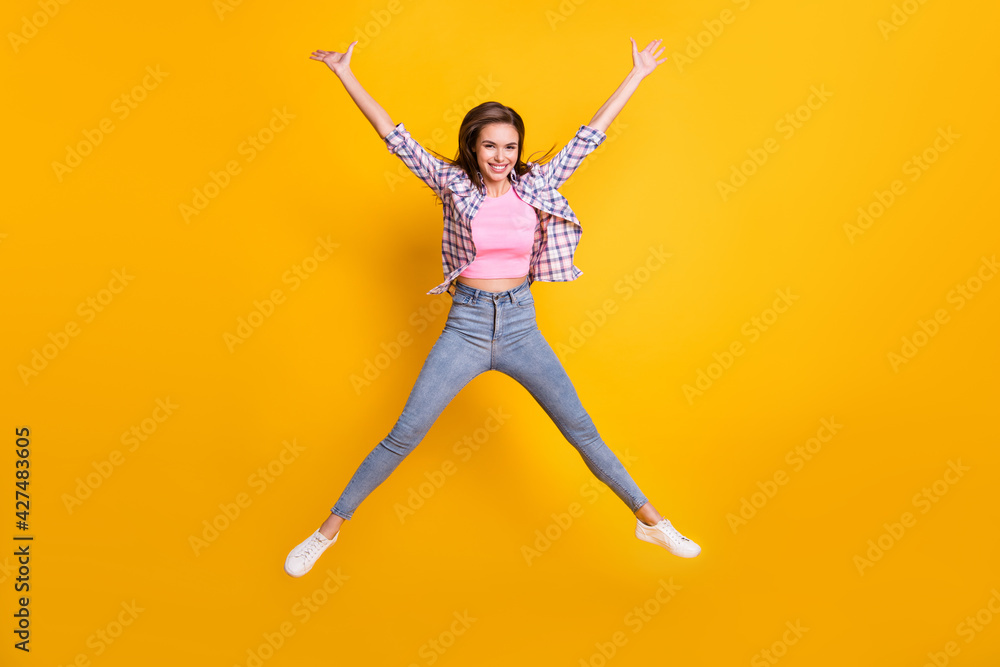 Full length body size view of lovely skinny cheerful girl jumping having fun fooling isolated over bright yellow color background