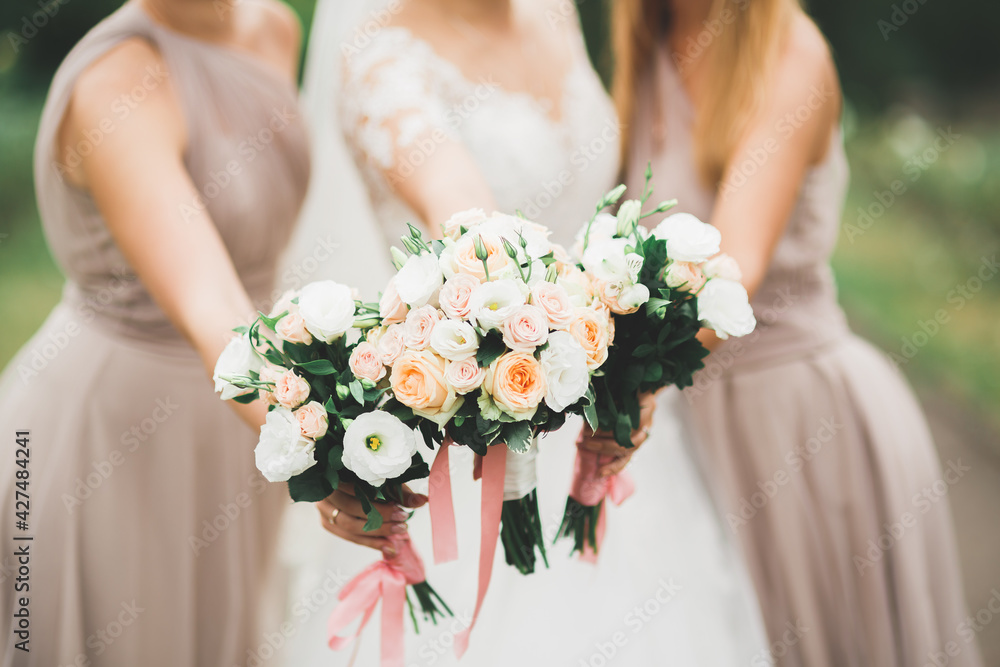 Bride holding big and beautiful wedding bouquet with flowers