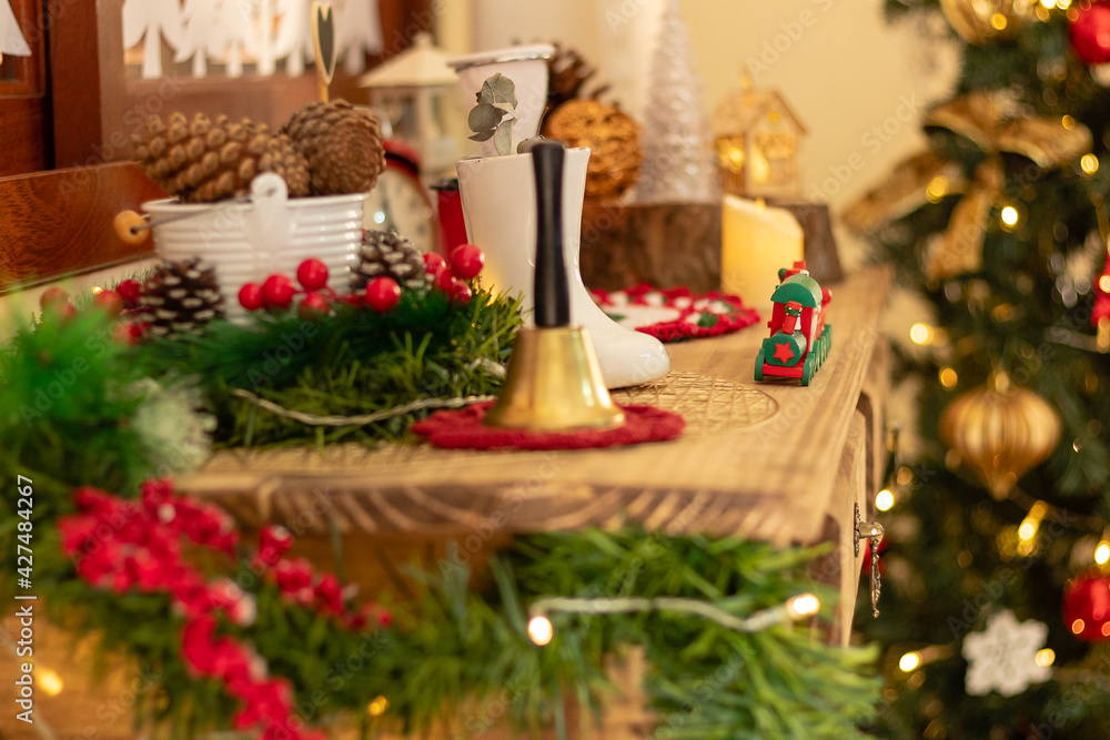 Christmas time. Close up and selective focus in a christmas train. Festive xmas tree decorated with warm lights on blurry background.