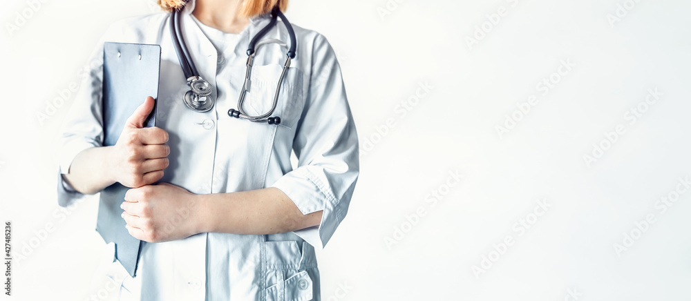 Female doctor with stethoscope holding clipboard in the hospital. Female doctor with stethoscope holding clipboard in the hospital.