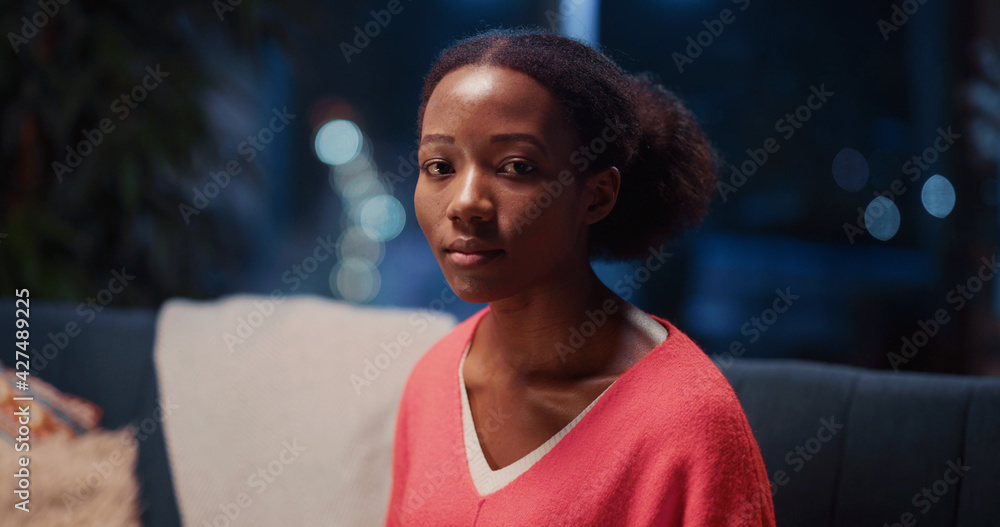 Indoor Portrait African American Pretty Young Woman Holding Cup with Coffee Spending Evening Leisure Activity Alone Looking for Camera. Home Lifestyle.