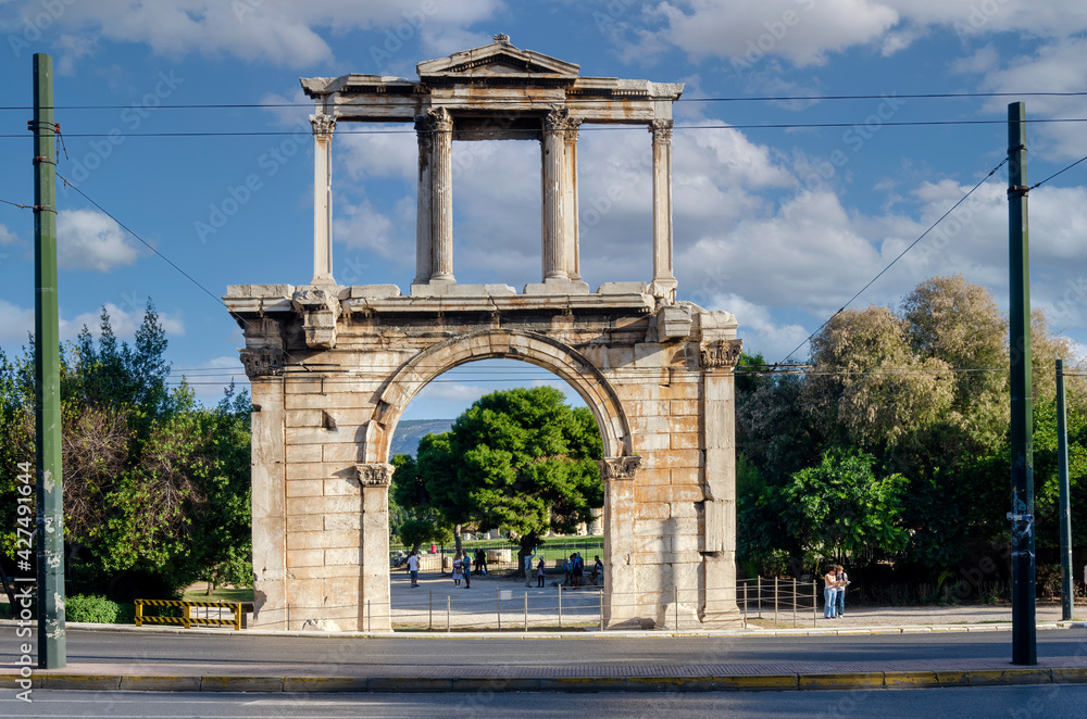 Fototapeta premium Athens, Attica, Greece. The Arch of Hadrian, most commonly known in Greek as Hadrian's Gate, is a monumental gateway resembling, in some respects, a Roman triumphal arch. Sunny day