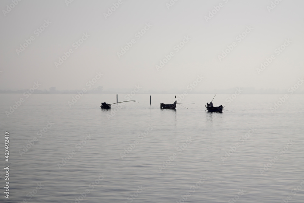 Naklejka premium Traditional fishing boats during toil