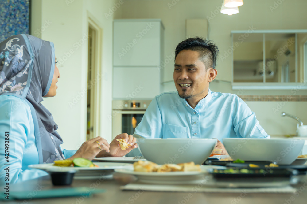 Eid Mubarak celebration moment, husband and wife at the dining table Eid Mubarak celebration moment, husband and wife at the dining table