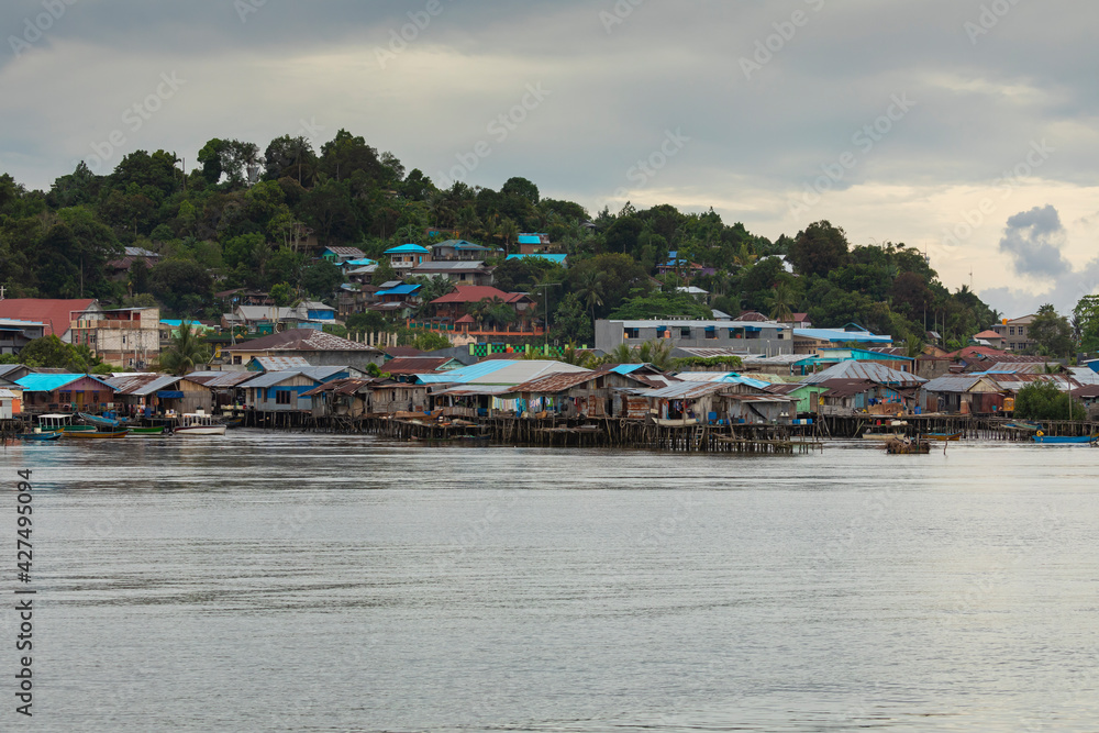 Skyline of humble little houses by the sea in the town of Sorong, West Papua, near the arrival area of the Waisai to Sorong ferry.