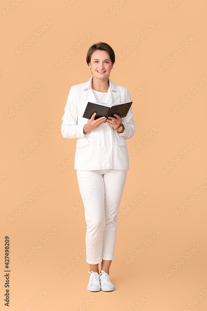Beautiful young woman with book on color background Beautiful young woman with book on color background