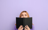Woman reading book on color background