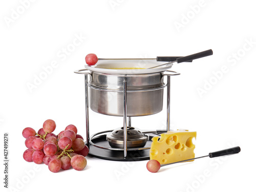 Cheese fondue and grapes on white background