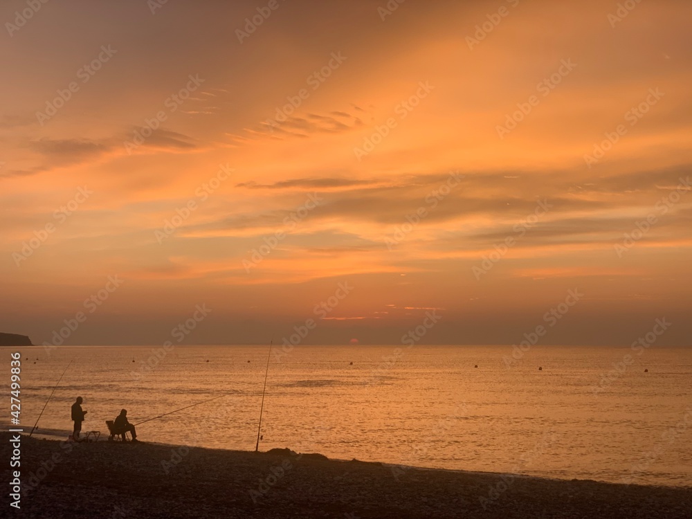 fisherman on the beach at sunrise