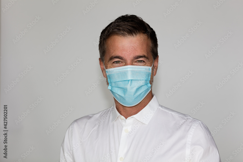 Man worker with mask looking at the camera. COVID-19 protection concept. Isolated on white Man worker with mask looking at the camera. COVID-19 protection concept. Isolated on white