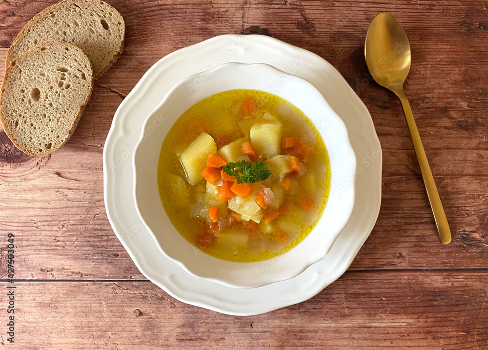 Healthy vegetarian vegetable soup with potatoes, carrots, celery and parsley. Healthy vegetarian vegetable soup with potatoes, carrots, celery and parsley.