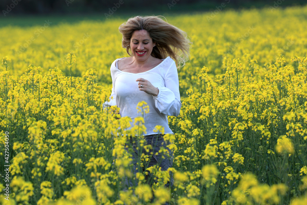 woman portrait with yellow flowers field background