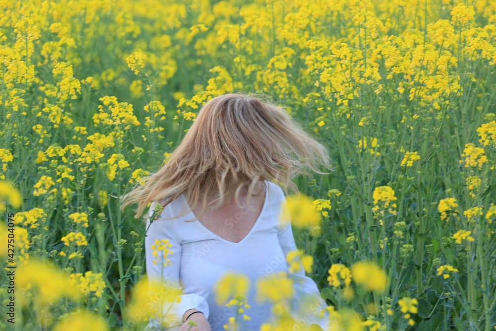 Fototapeta premium woman portrait with yellow flowers field background